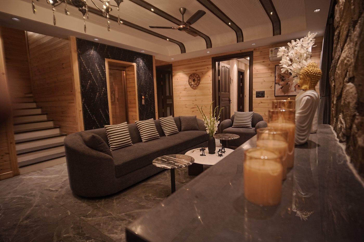 Premium villa living room in Dehradun with marble counter, Buddha statue, and designer decor