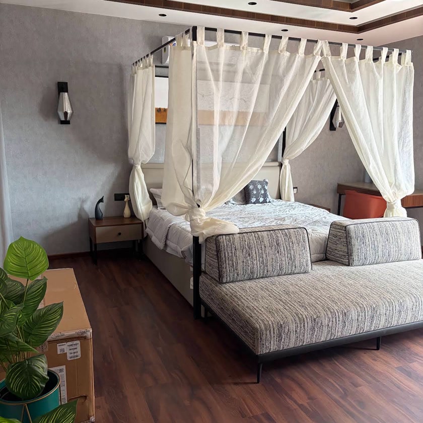 Master bedroom with sheer canopy and wooden ceiling