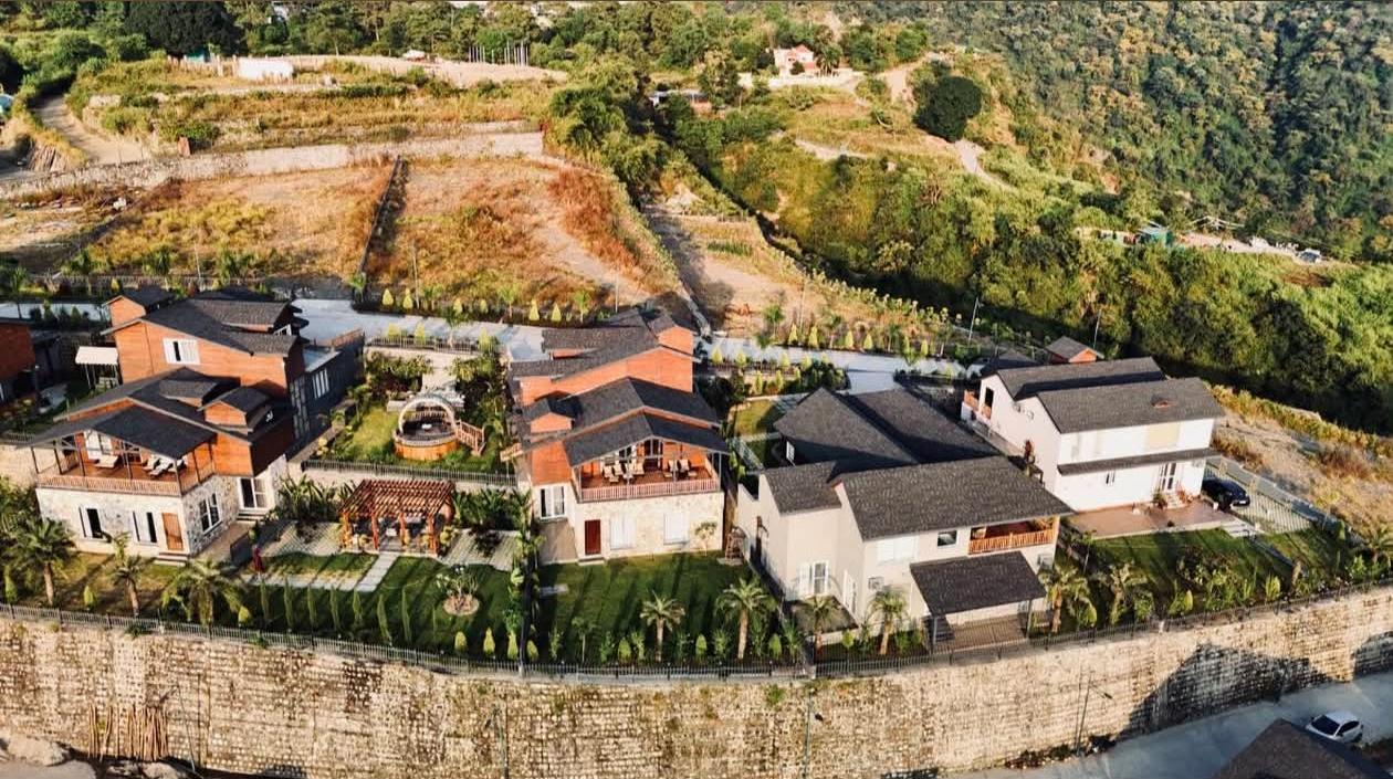 Aerial view of Hillcrest MDDA approved villas for sale in Dehradun with dramatic mountain backdrop