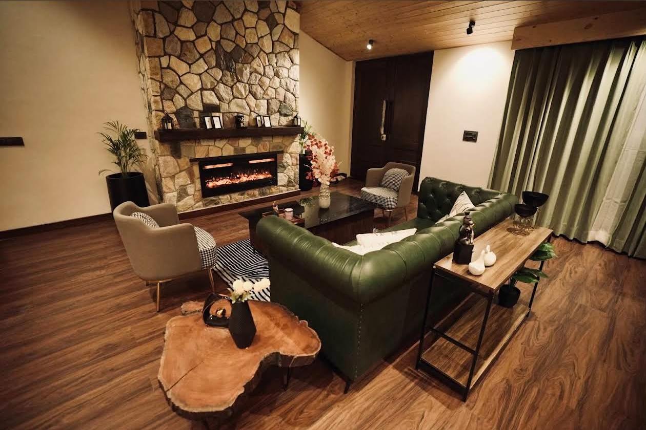 Living room with stone fireplace and olive sofa